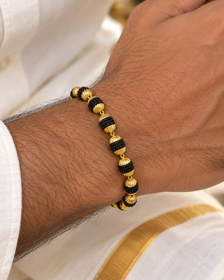 Elegant gold plated men’s bracelet featuring alternating black textured beads, ornate gold bead detailing, and a secure hook clasp, perfect for daily wear, festive occasions, and traditional looks.