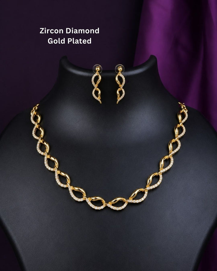 Beautiful gold plated loop necklace set featuring interlinked curved motifs accented with sparkling clear stones and matching elegant drop earrings. Perfect for daily wear, festive occasions, parties, traditional outfits, and premium gifting.