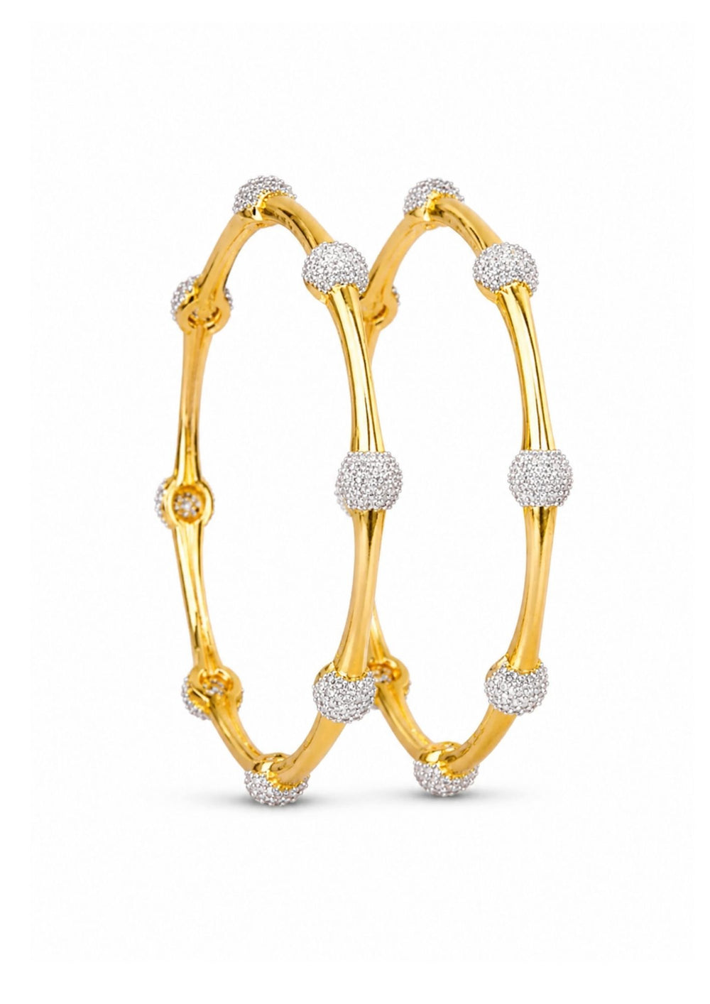 Gold plated bangles with diamond accents on a white background

