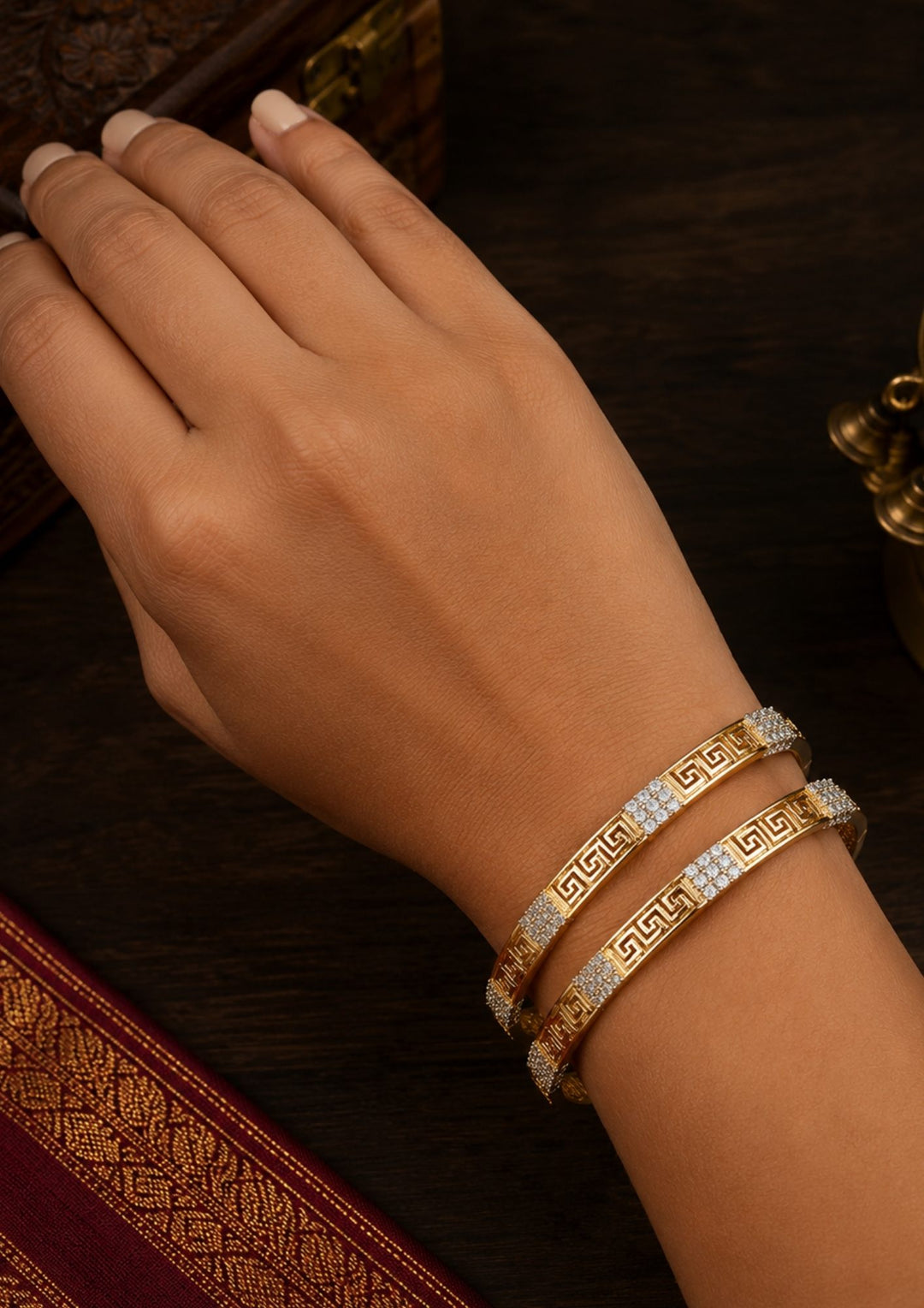 south indian women wearing a gold plated classic bangles come with zircon diamond and in picture shows clearly how it looks looks very classy and simple and ani faded and skin safe and can be used for daily ware, office ware and festivals