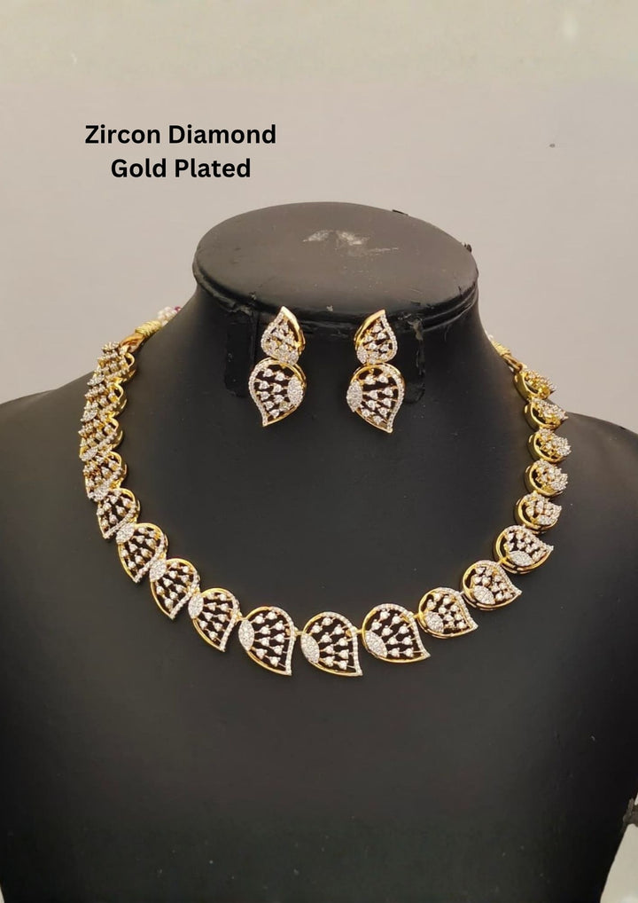 Gold plated jewelry set  featuring a delicate choker necklace made of repeating, stylized leaf or paisley-shaped links. Each openwork link is encrusted with brilliant, clear white Zirconian diamonds (American Diamonds) that catch the light beautifully. Includes a matching pair of elegant hanging earrings mimicking the exact leaf pattern. Crafted for festive occasions and parties with premium quality and Cash on Delivery available.