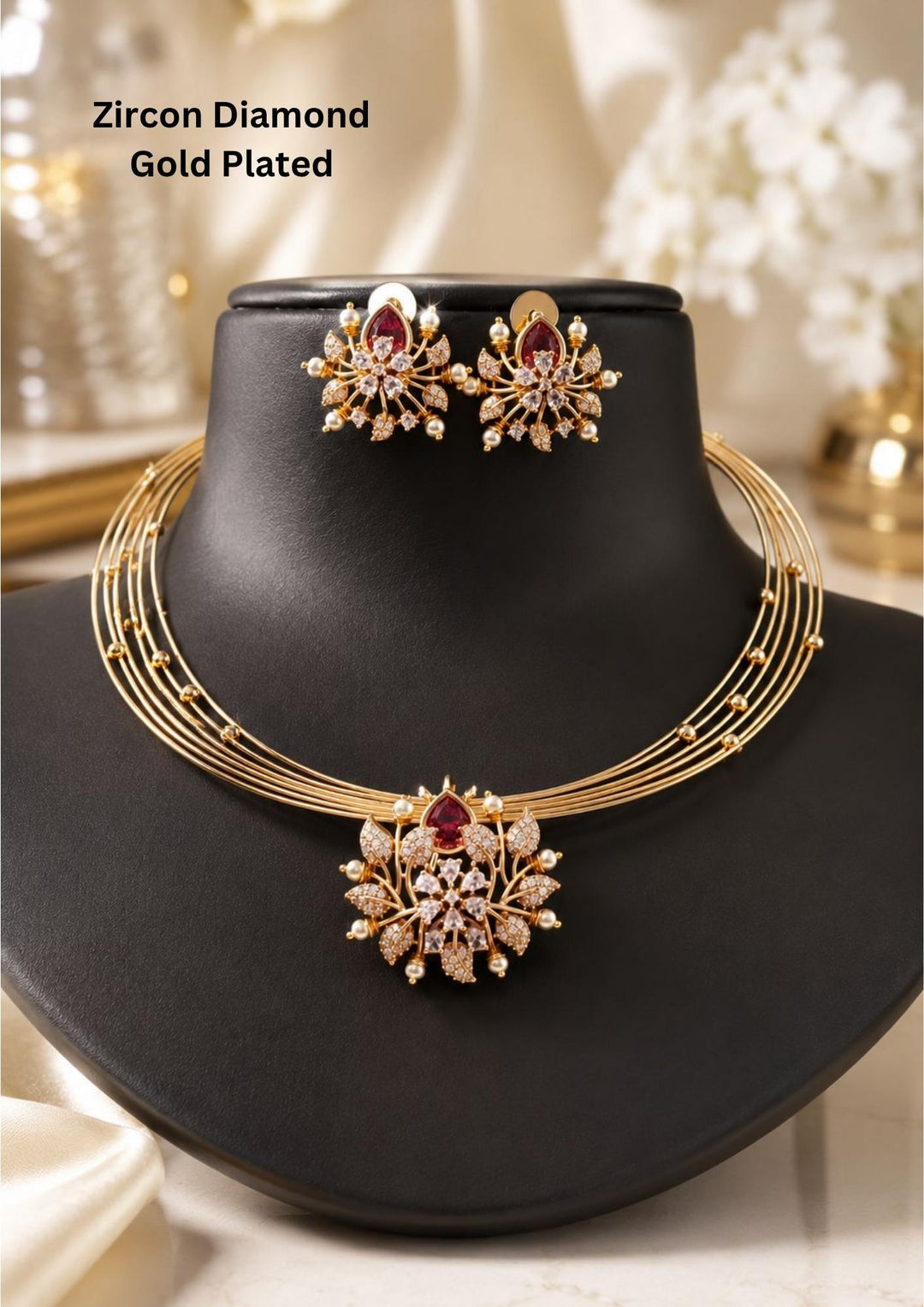 zircon diamond gold plated necklace with earrings designed with white pearls and leaf shaped gold beads with red emerald stone in middle. This necklace set has a premium gold finish, is lightweight, and comfortable to wear. Suitable for daily use, pooja, weddings, festivals, functions, and family occasions. It is sweat-proof, anti-fade, skin-friendly, and easy to wear daily