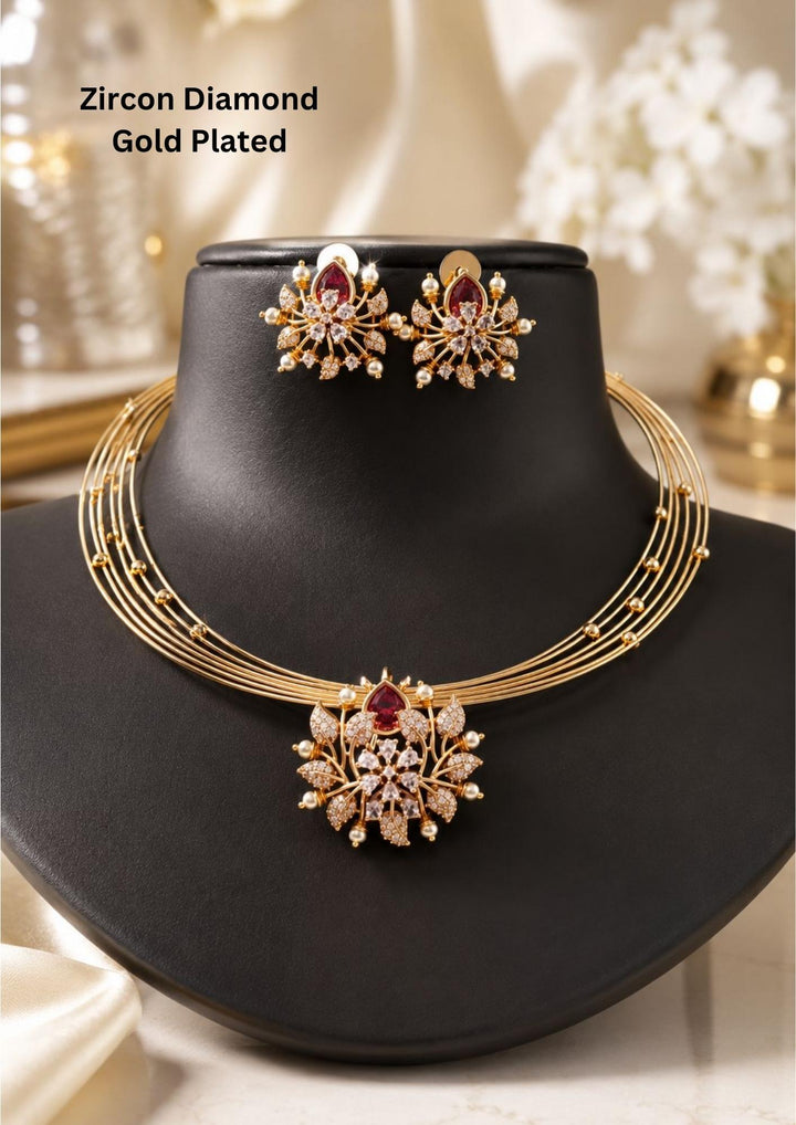 zircon diamond gold plated necklace with earrings designed with white pearls and leaf shaped gold beads with red emerald stone in middle. This necklace set has a premium gold finish, is lightweight, and comfortable to wear. Suitable for daily use, pooja, weddings, festivals, functions, and family occasions. It is sweat-proof, anti-fade, skin-friendly, and easy to wear daily