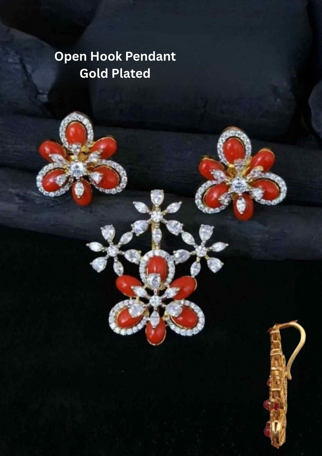 Open Hook Pendant Gold Plated jewelry set with one floral locket pendant and matching pair of earrings designed with red coral style stones and sparkling white zircon diamond detailing. The locket features flower petal pattern with hanging floral branch design and the earrings come with matching flower design finished in shiny gold plating. This lightweight jewelry set comes with sweat proof quality, anti-fade colour, skin-friendly finish, smooth fitting, and is suitable for daily wear, functions, parties, 