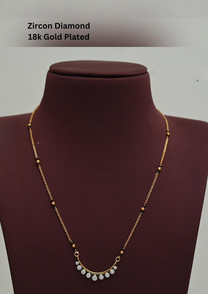 Gold plated black beads mangalsutra featuring an elegant butterfly-inspired zircon centerpiece with delicate Crescent Shape  detailing. Lightweight and beautifully crafted for everyday elegance, festive occasions, and gifting.