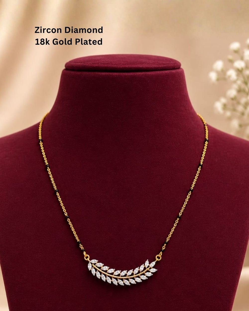 Traditional gold plated mangalsutra necklace with black beads and a delicate leaf-inspired CZ pendant, perfect for daily and festive styling.