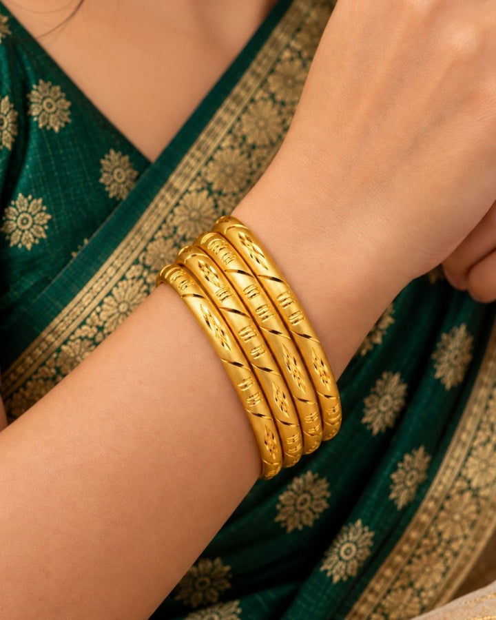Beautiful 18K gold plated bangles featuring floral engravings and polished detailing that enhance every festive and traditional outfit. perfect for weddings, festivals, and daily ethnic wear.