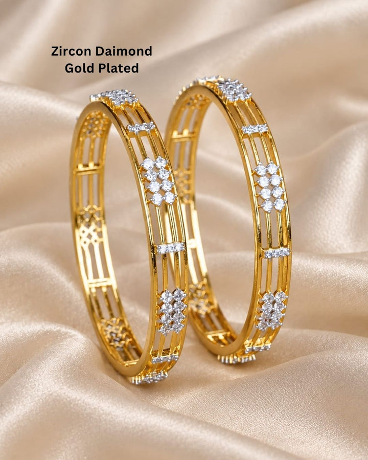 Gold plated designer bangles featuring a sleek triple-line structure with sparkling white CZ floral stone clusters and rectangular stone accents.