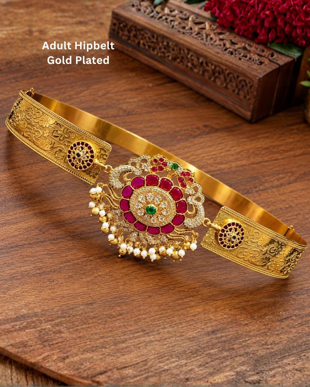 Traditional gold plated women’s hip belt with an intricately detailed floral centerpiece, colorful stones, sparkling accents, and pearl drops, perfect for festive and ethnic occasions.