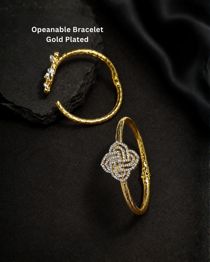 Beautiful gold plated designer kada pair featuring intricate peacock motifs embellished with sparkling CZ stones and subtle pink accents. Perfect for festive occasions, traditional wear, celebrations, and gifting.
