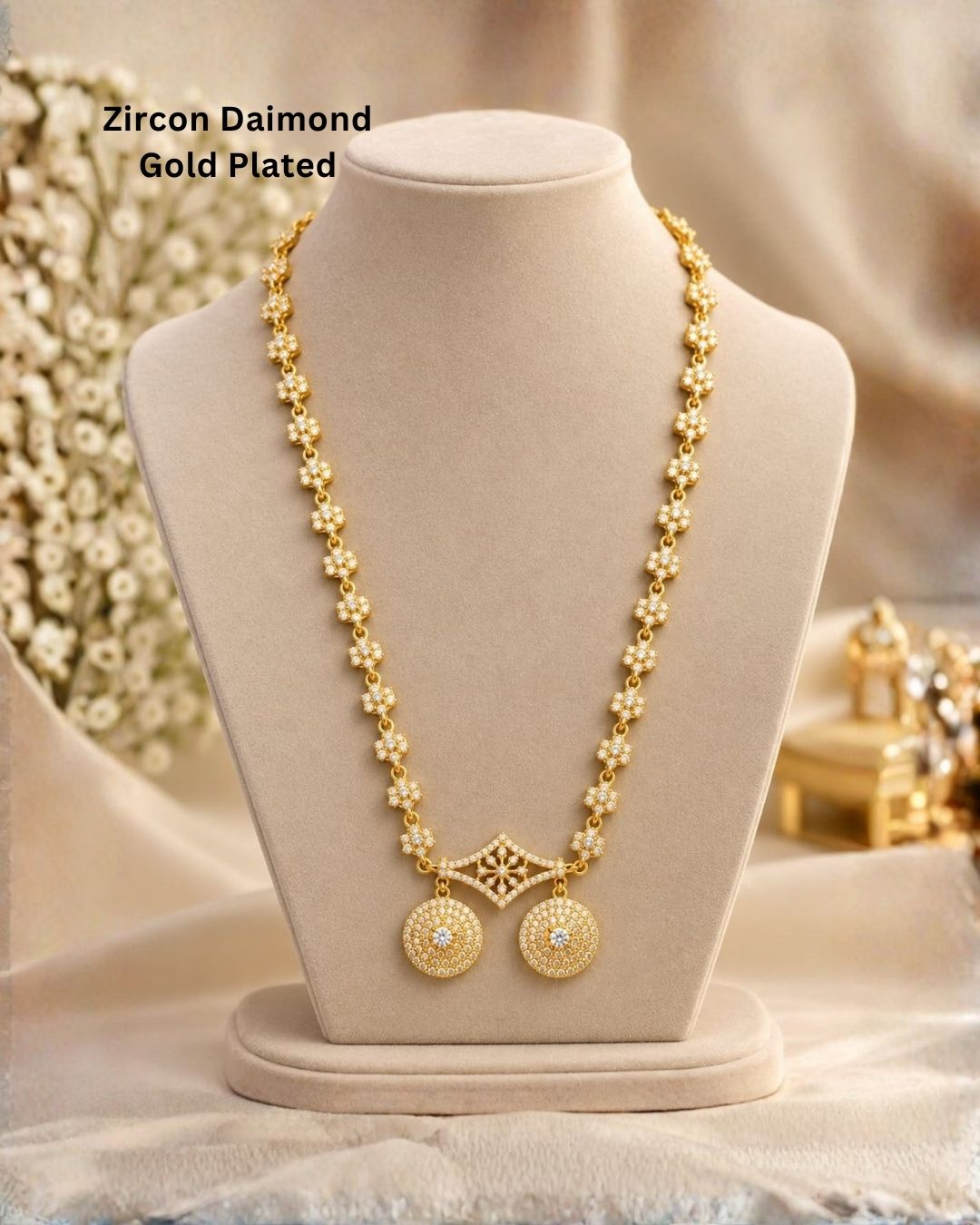 Elegant gold plated necklace with sparkling white stones, floral motifs, and two round dangling pendants.