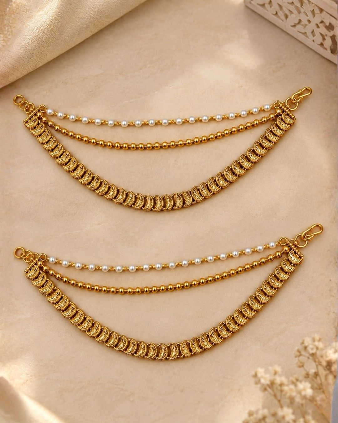 Gold plated traditional ear chains featuring pearl beads, gold ball chains, and intricately detailed antique gold links.