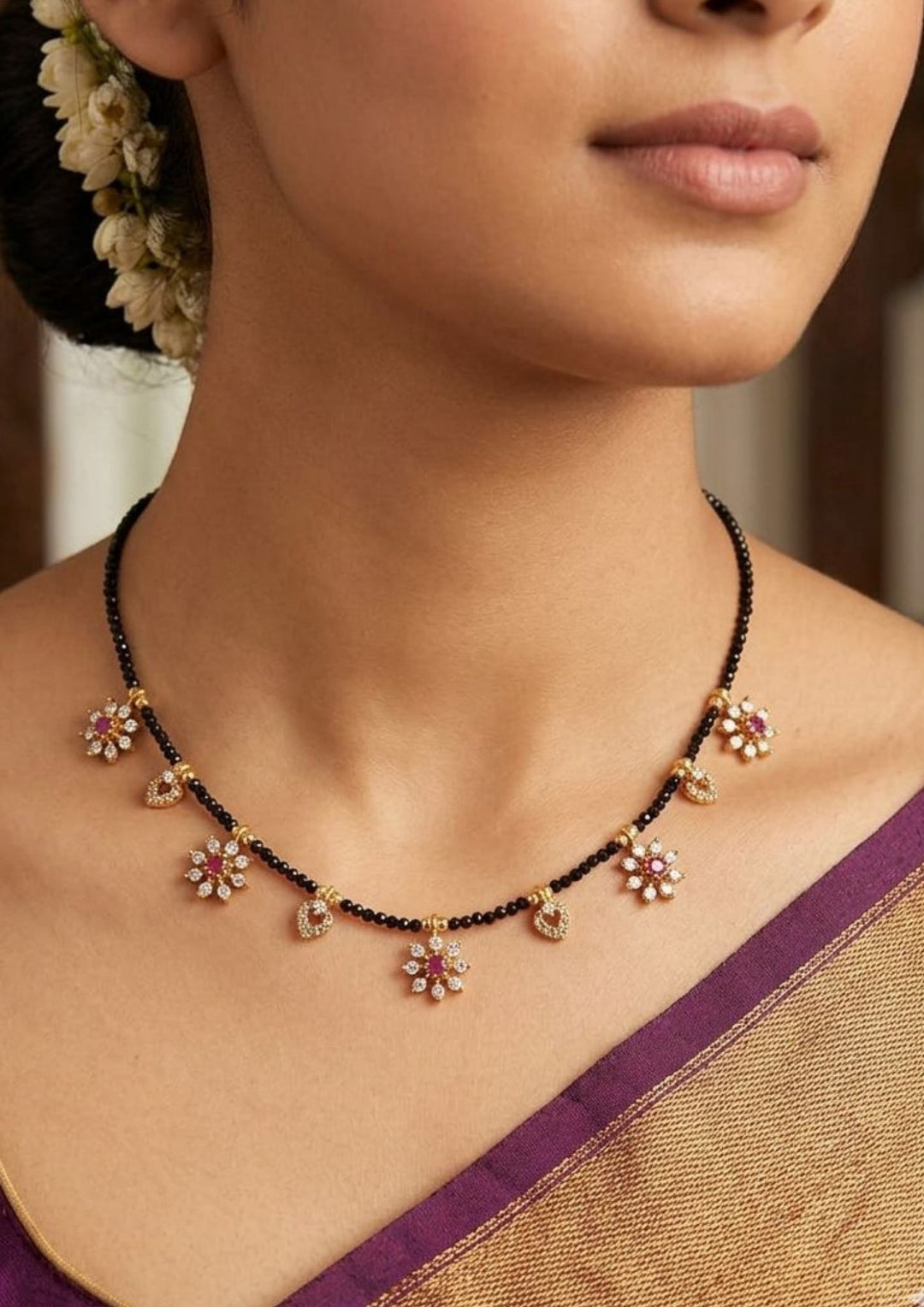 Close-up of a woman wearing a floral necklace where most south Indian women's wore this (nallapusallu) and how women look gave it with in detailed and can use for dailyware, festival , functional 