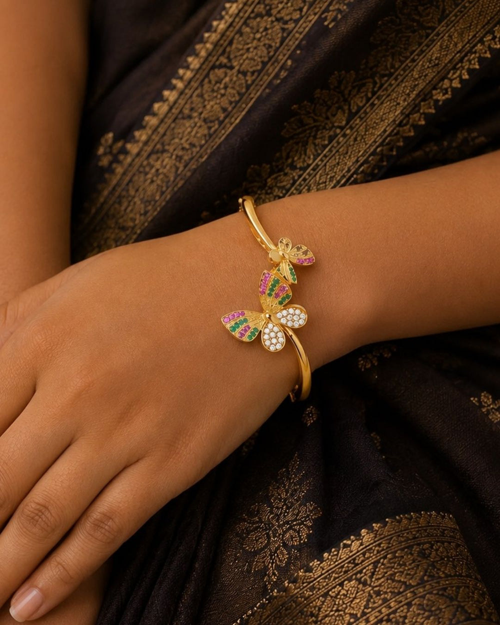 South indian women's Elegant gold plated butterfly bracelet crafted with CZ diamonds, vibrant pink and green stones, and a modern openable design for traditional and party occasions.