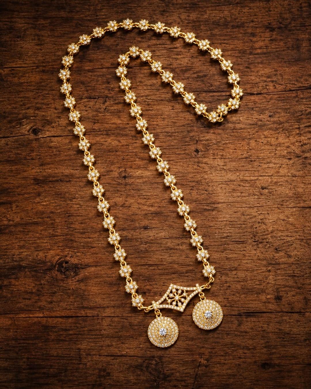Elegant gold plated necklace with sparkling white stones, floral motifs, and two round dangling pendants.