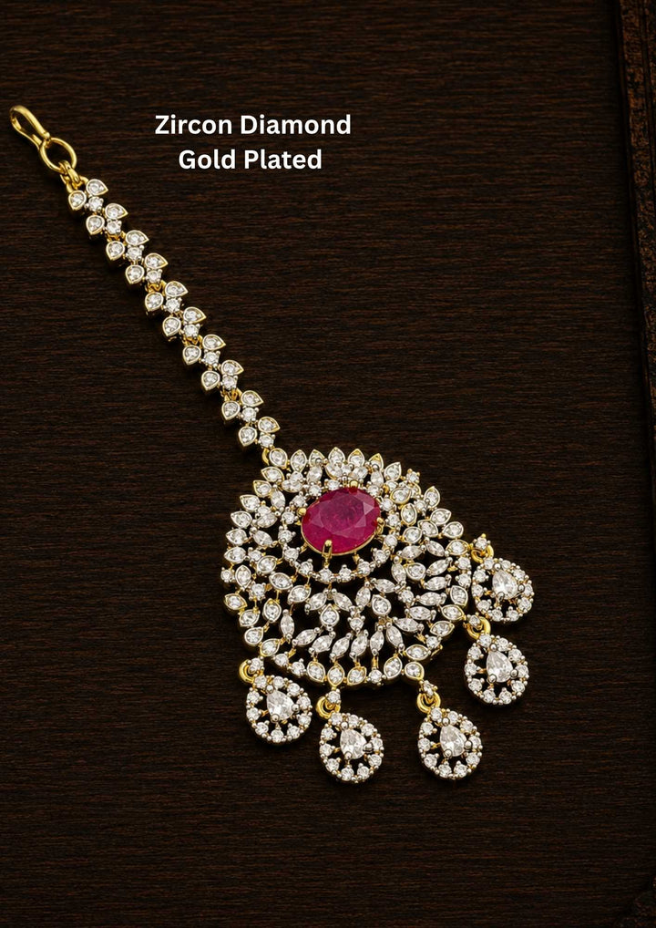 Gold-plated Zircon Diamond Mangtikka (papidi billa) shows in picture clearly how it looks and comes with Red stone and can be used for weeding's and festivals 