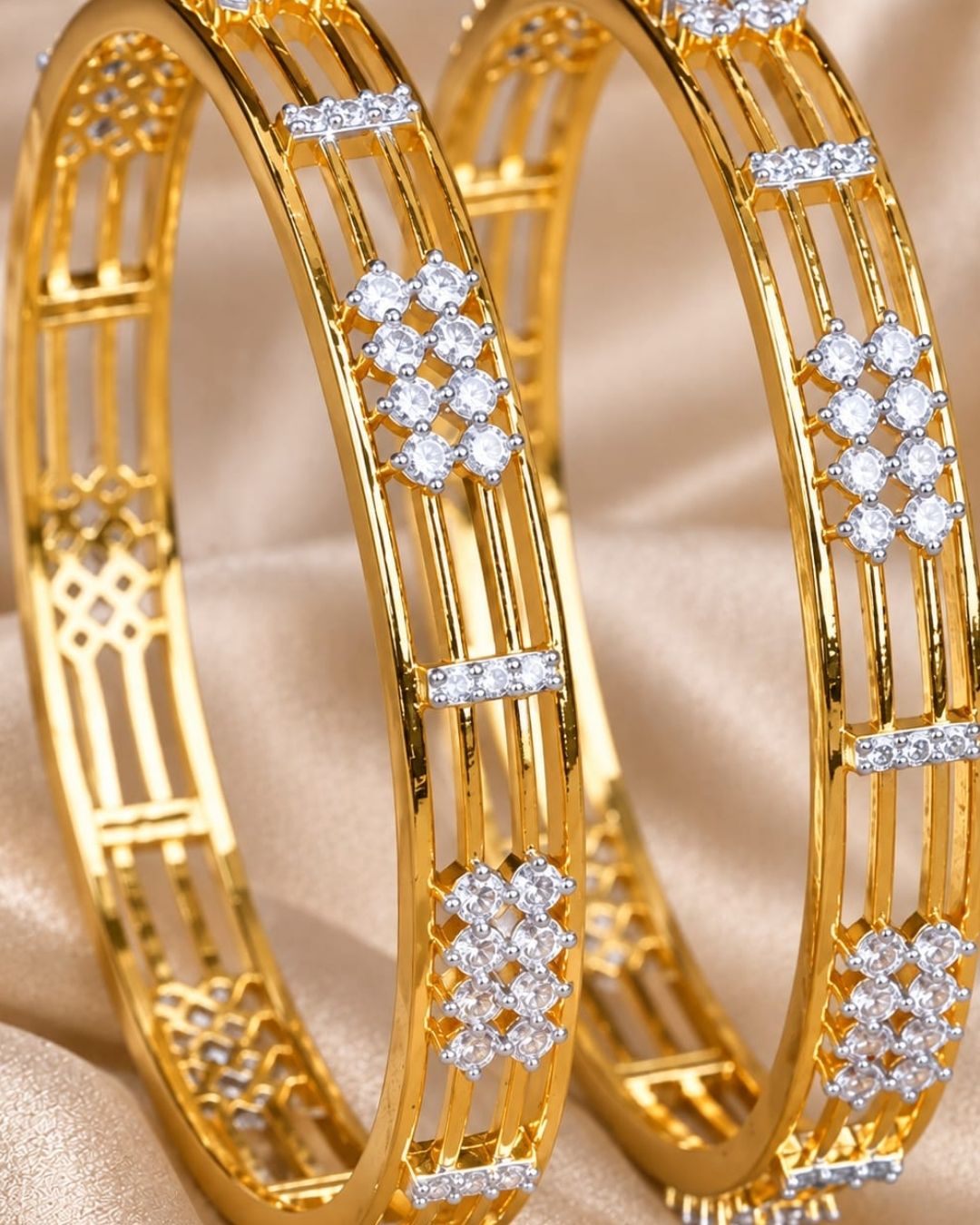 Gold plated designer bangles featuring a sleek triple-line structure with sparkling white CZ floral stone clusters and rectangular stone accents.