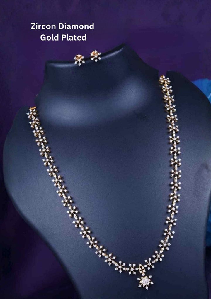 Zirconian Diamond Gold Plated long chain necklace and matching stud earrings set. The jewelry designed with floral pattern made of sparkling cube zirconia stones on a gold-plated base for festivals, temple visits, weddings, functions and dailywear