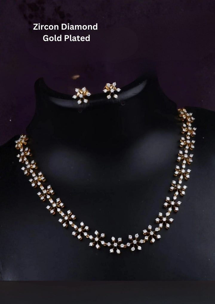 Zircon diamond flower design gold plated necklace set with flower-shaped zircon diamond pattern, matching floral earrings, and elegant stone arrangement finished with shiny gold plating. The necklace set comes with lightweight comfort, sweat proof quality, anti-fade colour, skin-friendly finish, smooth fitting, and is suitable for functions, festivals, weddings, parties, and traditional jewelry wear and ideal for gifting. 