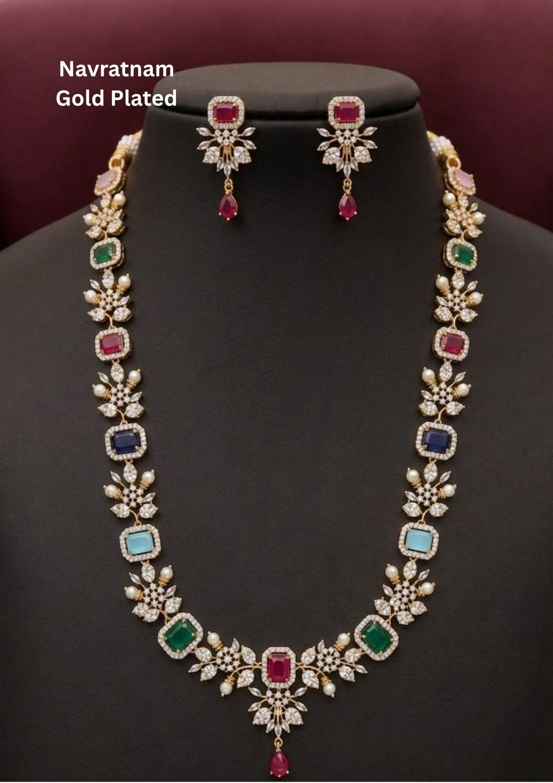 Gold-plated navratnam necklace and earrings set designed with pink, green , red, blue gemstones in a flower shape design with white american diamonds and this long haram set comes with matching flower shaped earring with pink gemstone. perfect for weddingwear, functions. its anti fade color and sweat proof