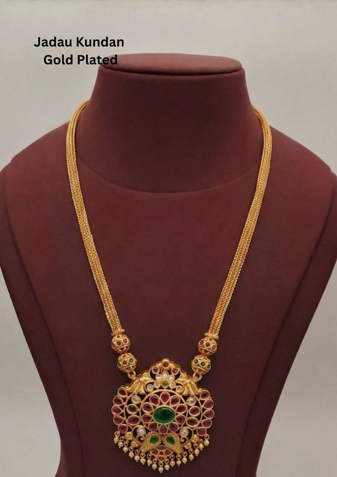 Gold-plated necklace design with long necklace with green and red stones come with jadau kundan in necklace with beads and in pendent shows clear design and in detailed shown in picture it will not fade color and water proof can used for festivals, bridals, and weeding's  