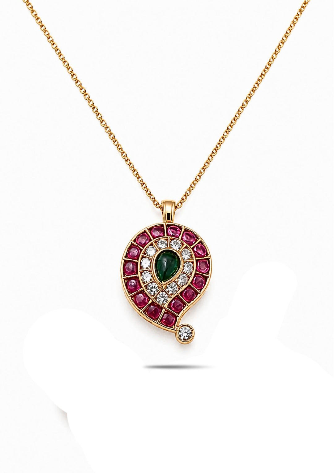 Gold Plated mango pendant locket designed with mango shape pattern with pink ruby style stones, emerald green center stone with white zircon and the chian in the link patteren design in 18k gold plating. This elegant ethnic pendant comes with lightweight comfort, sweat proof quality, anti-fade colour, skin-friendly finish, and smooth fitting suitable for weddings, festivals, traditional wear, parties, and gifting purposes. 