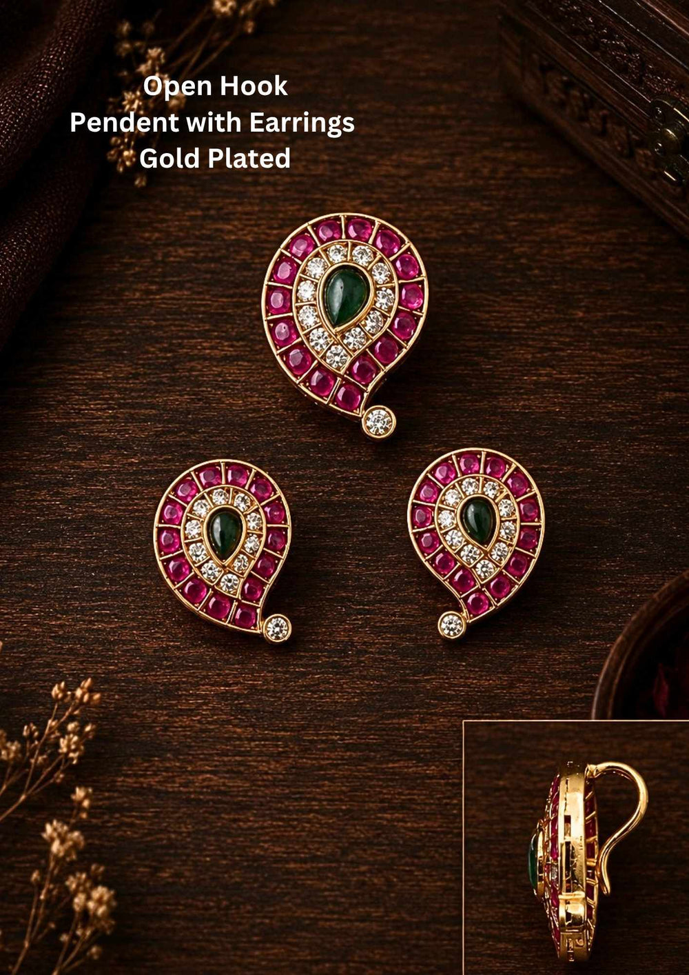 Jadau Kundan Gold Plated mango pendant set with matching earrings designed in traditional mango shape pattern with pink ruby stones, green center kundan stone, and sparkling white zircon detailing. The pendant is with open hook style and finished in rich 18k gold plating that gives a royal ethnic jewelry look. This lightweight jewelry set comes with sweat proof quality, anti-fade colour, skin-friendly finish, smooth fitting, and is suitable for weddings, festivals, dailywear