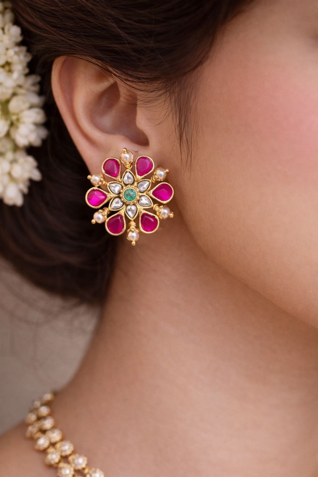 Close-up of a person wearing this Jadau kundan Screwback Studs.