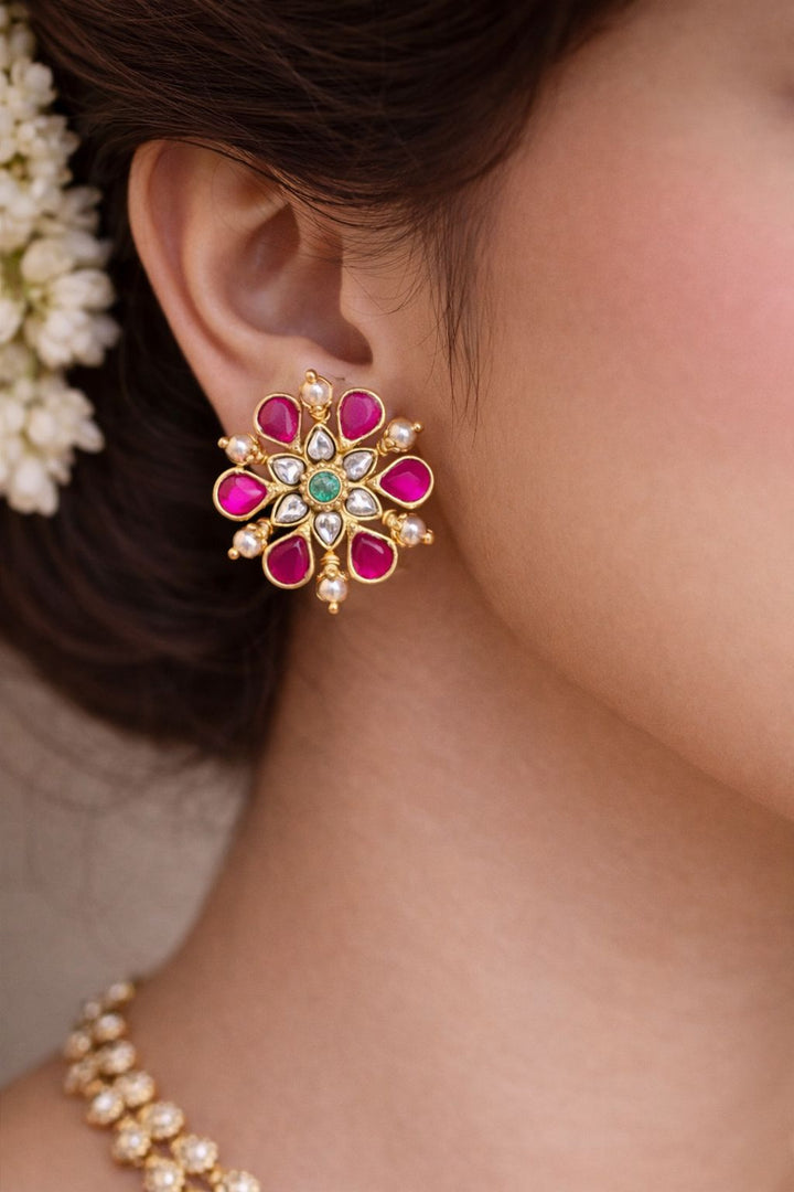 Close-up of a person wearing this Jadau kundan Screwback Studs.
