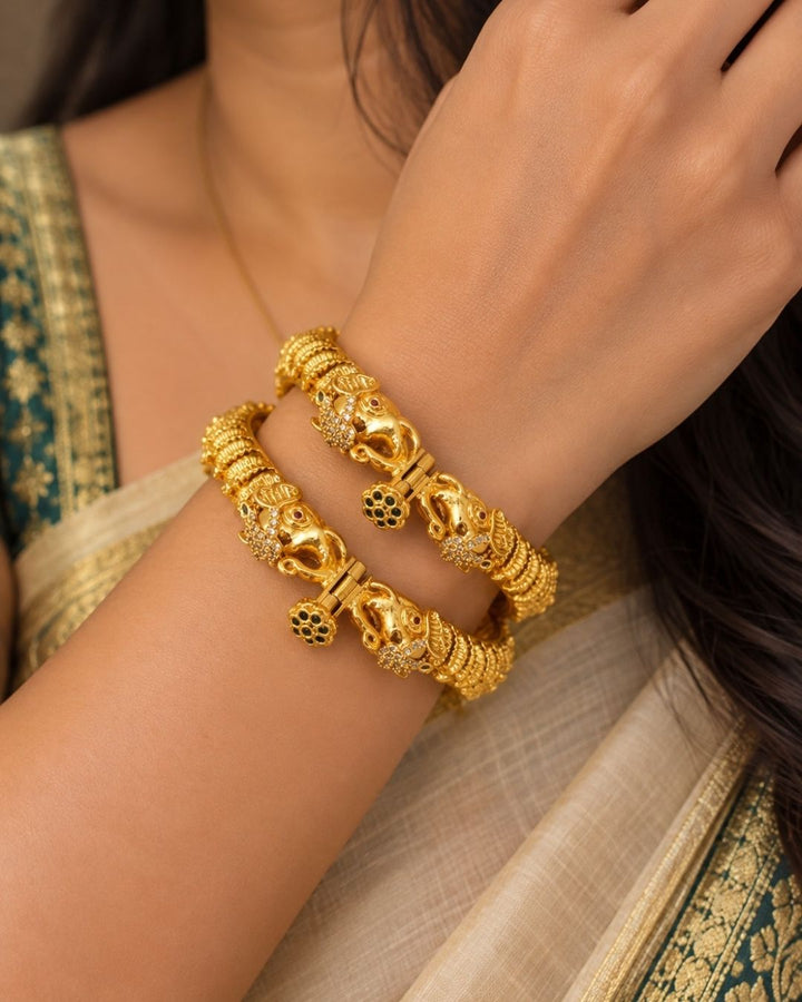 Elegant gold plated openable Kankanalu kada featuring beautifully detailed elephant motifs, intricate traditional patterns, and a polished gold finish, perfect for festive and traditional wear.