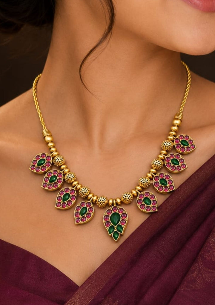 Beautiful Jadau Kundan gold plated necklace featuring pear-shaped kundan motifs, detailed gold beadwork, and elegant craftsmanship. Perfect for weddings, festivals, temple visits, traditional outfits, family functions, and premium gifting.
