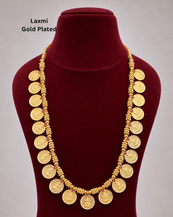 Traditional gold plated designer necklace featuring multiple Goddess Lakshmi coin motifs arranged along a detailed beaded chain, accented with small ruby-colored stones, perfect for festive, wedding, and traditional occasions.