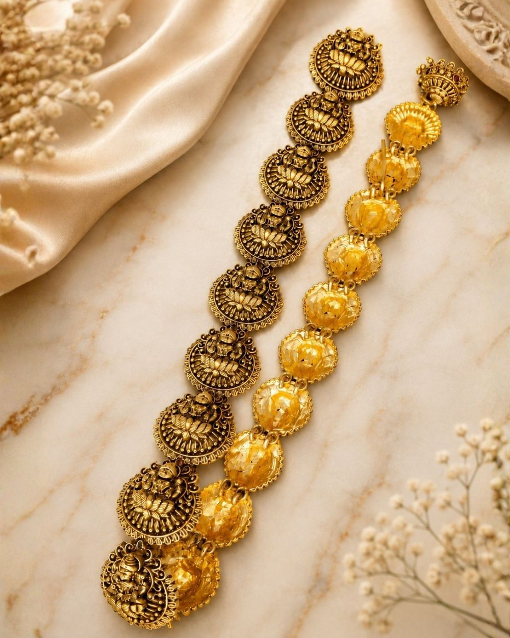 Gold-toned traditional Indian jewelry set featuring a necklace and matching earrings displayed on a black mannequin bust. The pieces are decorated with red gemstone accents and white pearl bead borders.