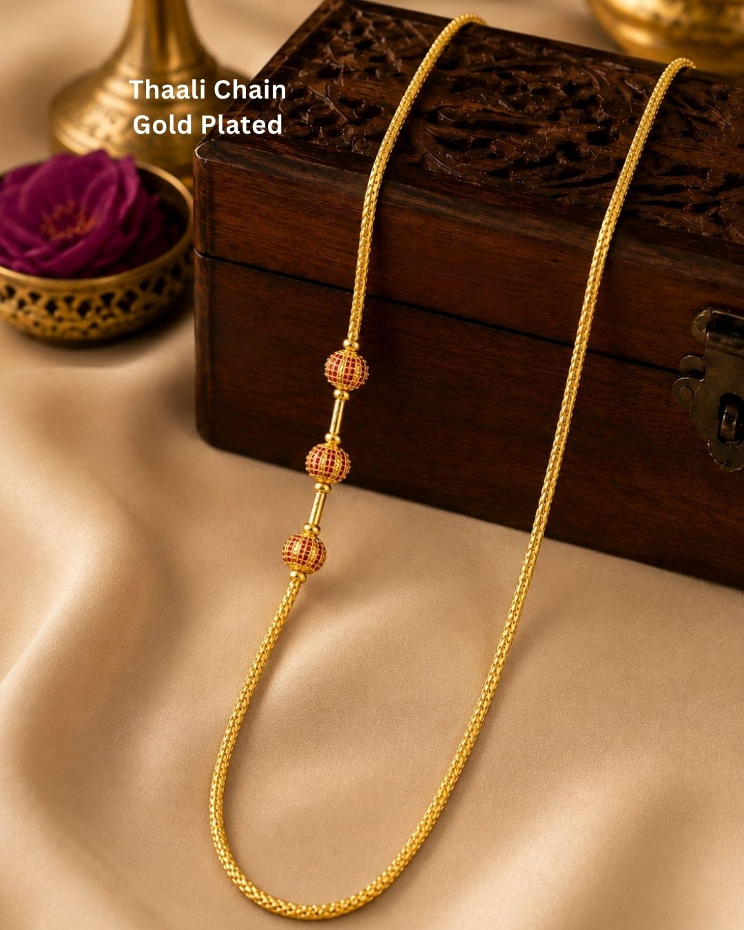 Stylish gold plated long chain featuring a fine textured design and three red and gold decorative beads. Perfect for traditional outfits, festive occasions, temple events, and special celebrations.