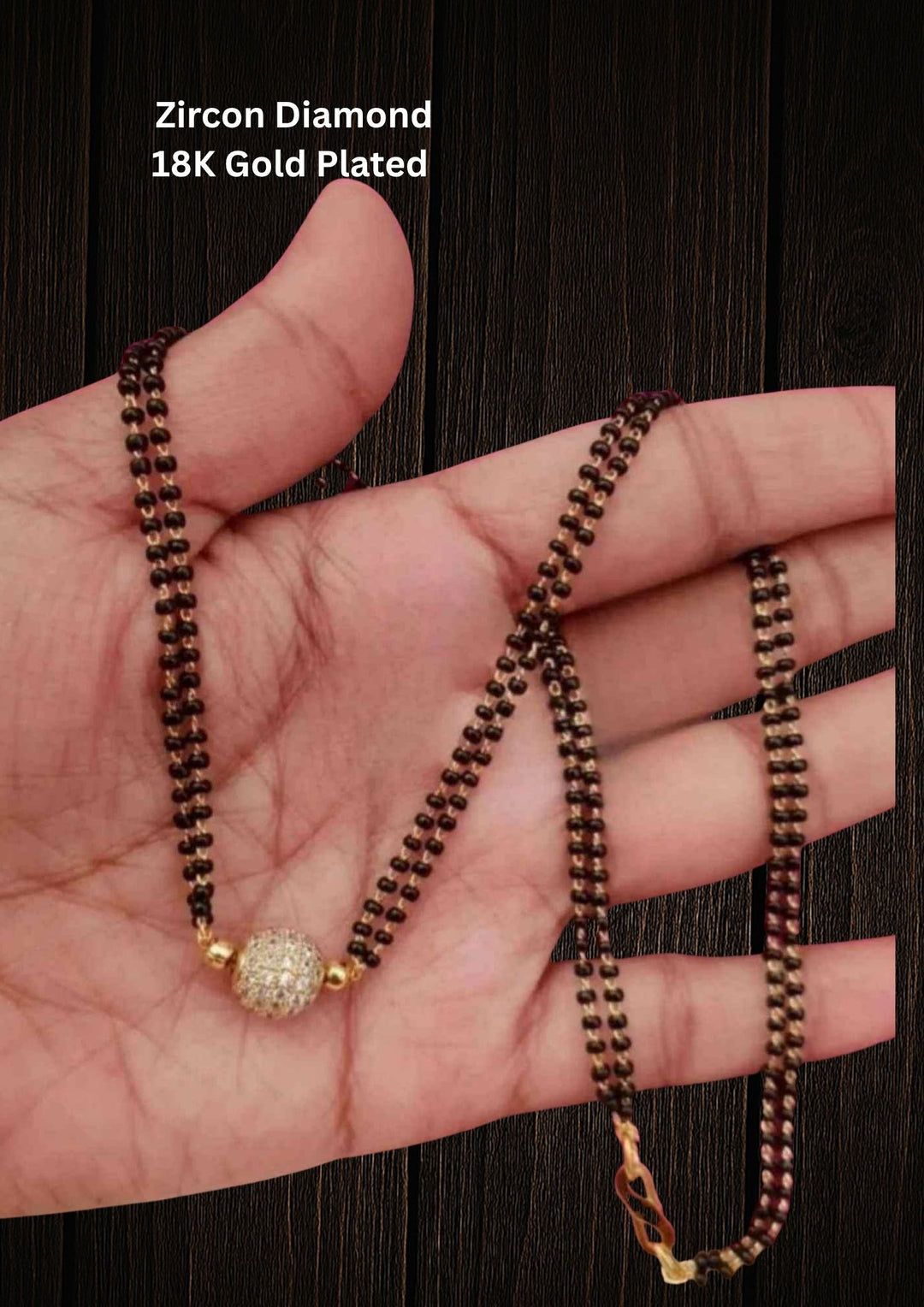 Gold Plated Ball Pendant Mangalsutra with double line and comes with zircon diamond looks with neat finish and can use for daily ware, festive ware, and can gift 