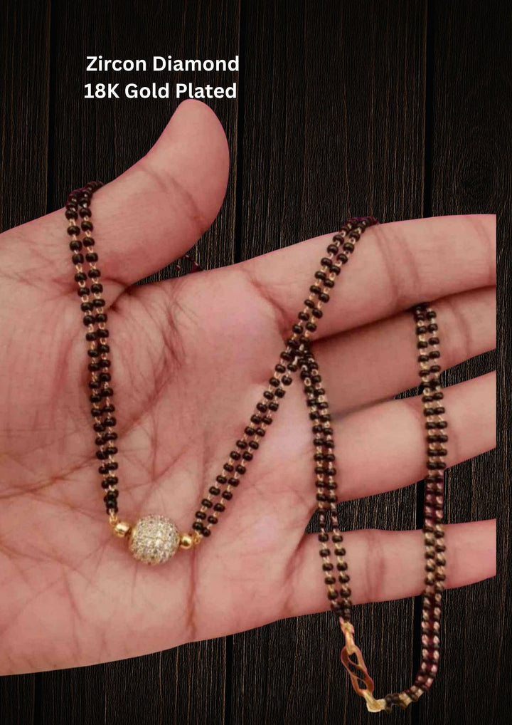 Gold Plated Ball Pendant Mangalsutra with double line and comes with zircon diamond looks with neat finish and can use for daily ware, festive ware, and can gift 
