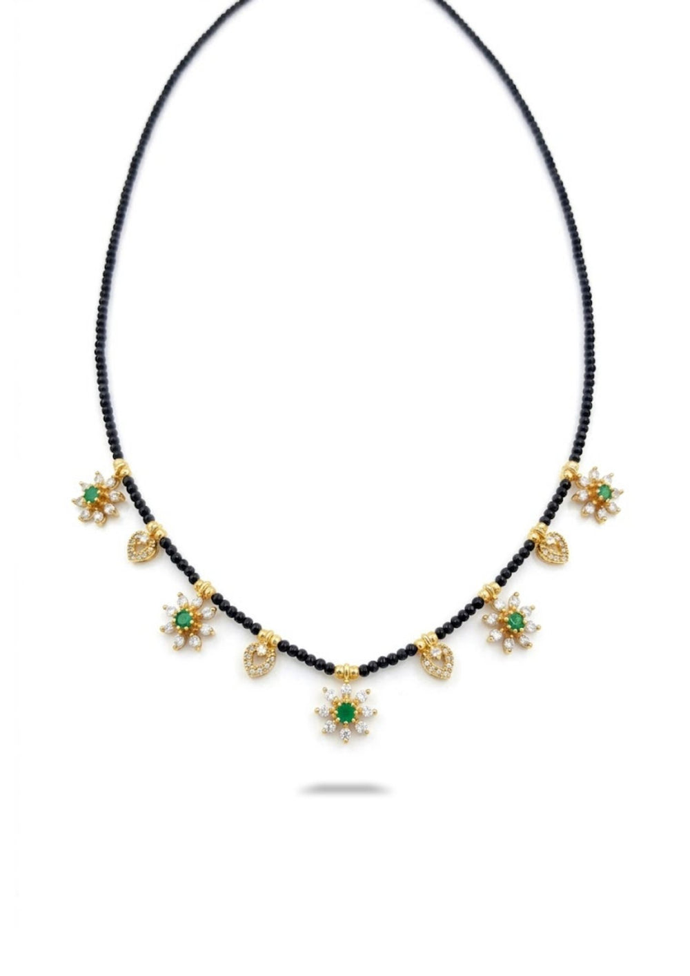 Necklace with gold and green star-shaped pendants on a white background
