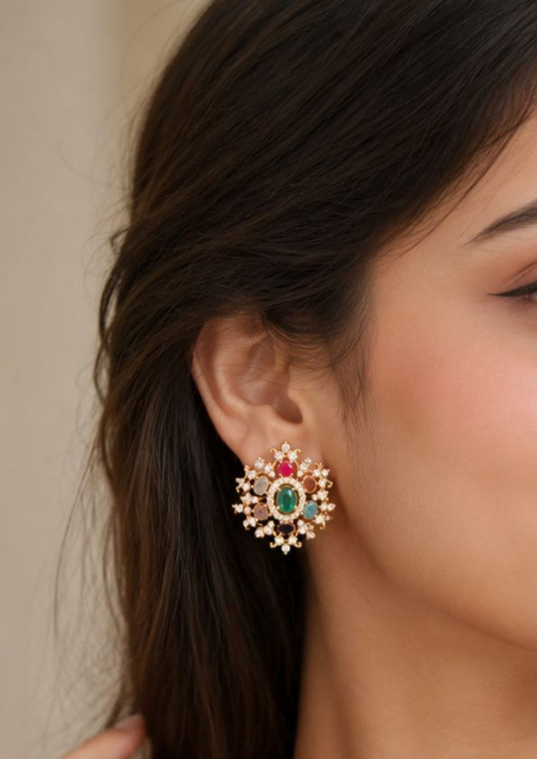 Close-up of an ear wearing a navarthnam  studs and close see the detailing of the studs with shine and  classy look can be used for dailyware, functional ware and for gifting 