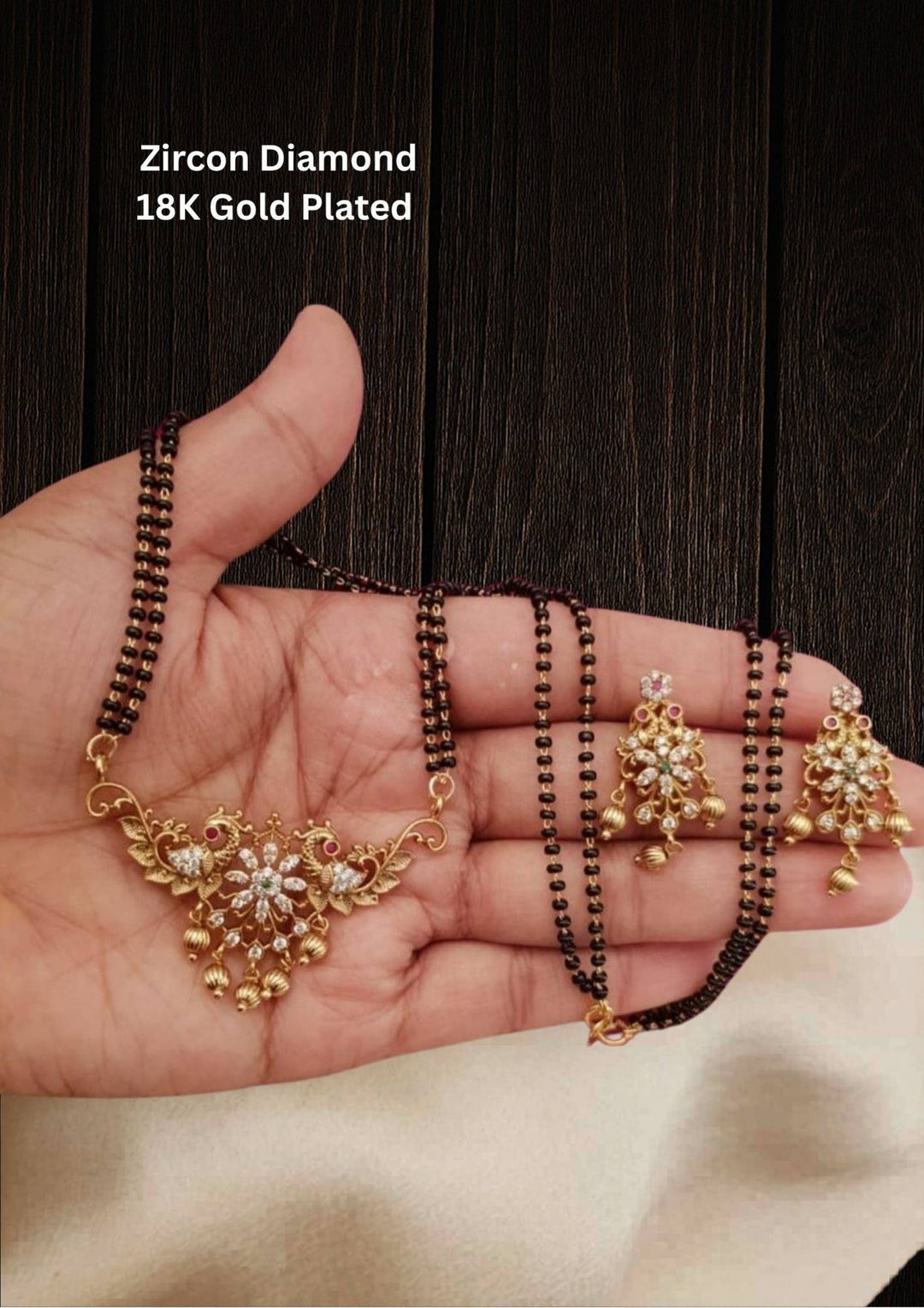 Gold plated jewelry set including Mangalsutra and earrings and it comes with peacock design and pendent and  earrings shows very clear in the picture 