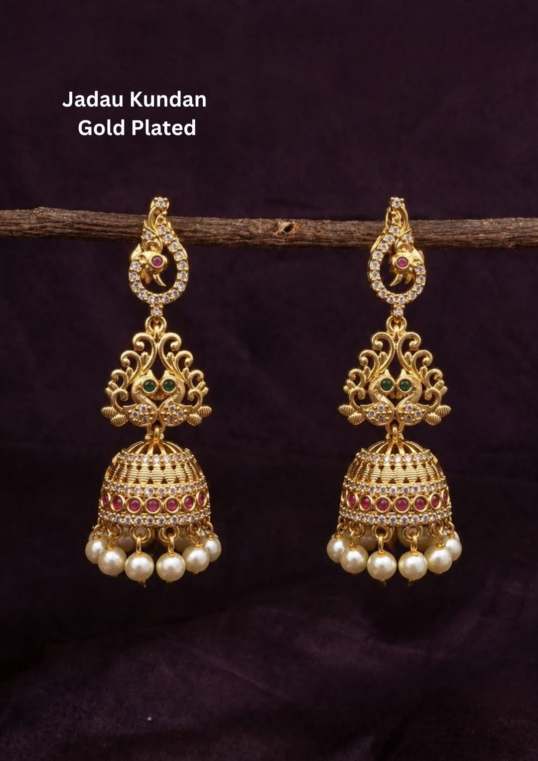 gold-plated Jadau Kundan earrings  a pair of sleek gold  Jhumkas with a peacock modern design. The pattern alternates between Peral drop's Jhumkas shiny gold blocks and blocks filled with sparkling white crystals.