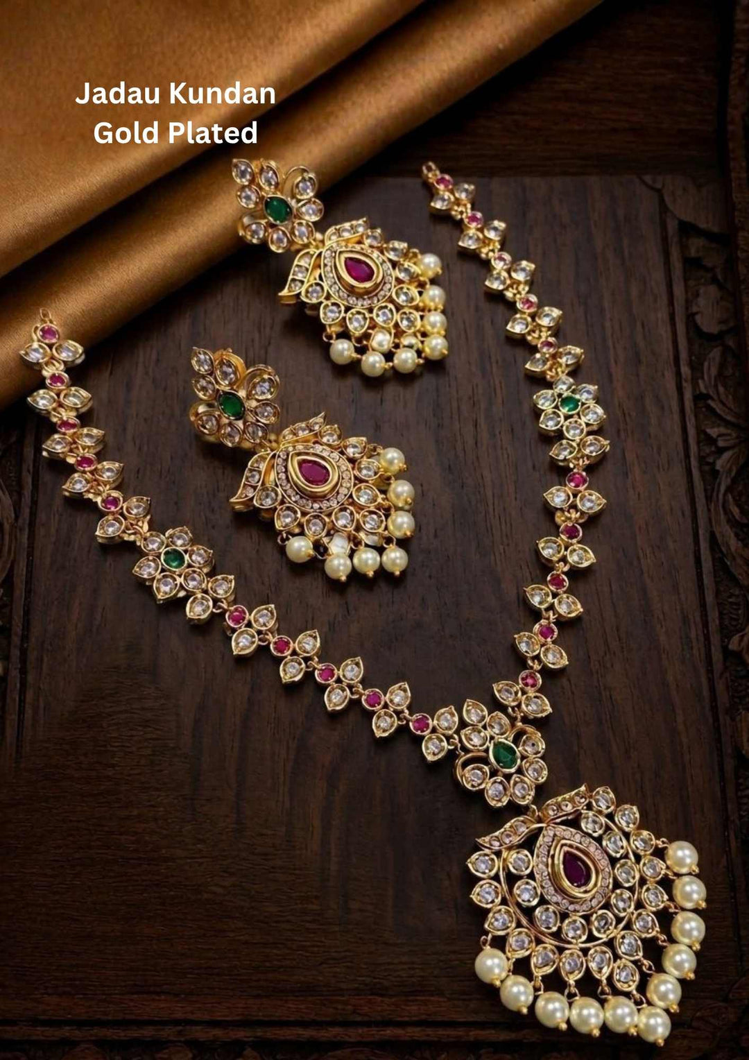 Gold-plated necklace with intricate design necklace with earrings and green and red stones come with jadau kundan in necklace and earrings with beads and in pendent shows clear design and in detailed shown in picture it will not fade color and water proof can used for festivals, bridals, and weeding's  