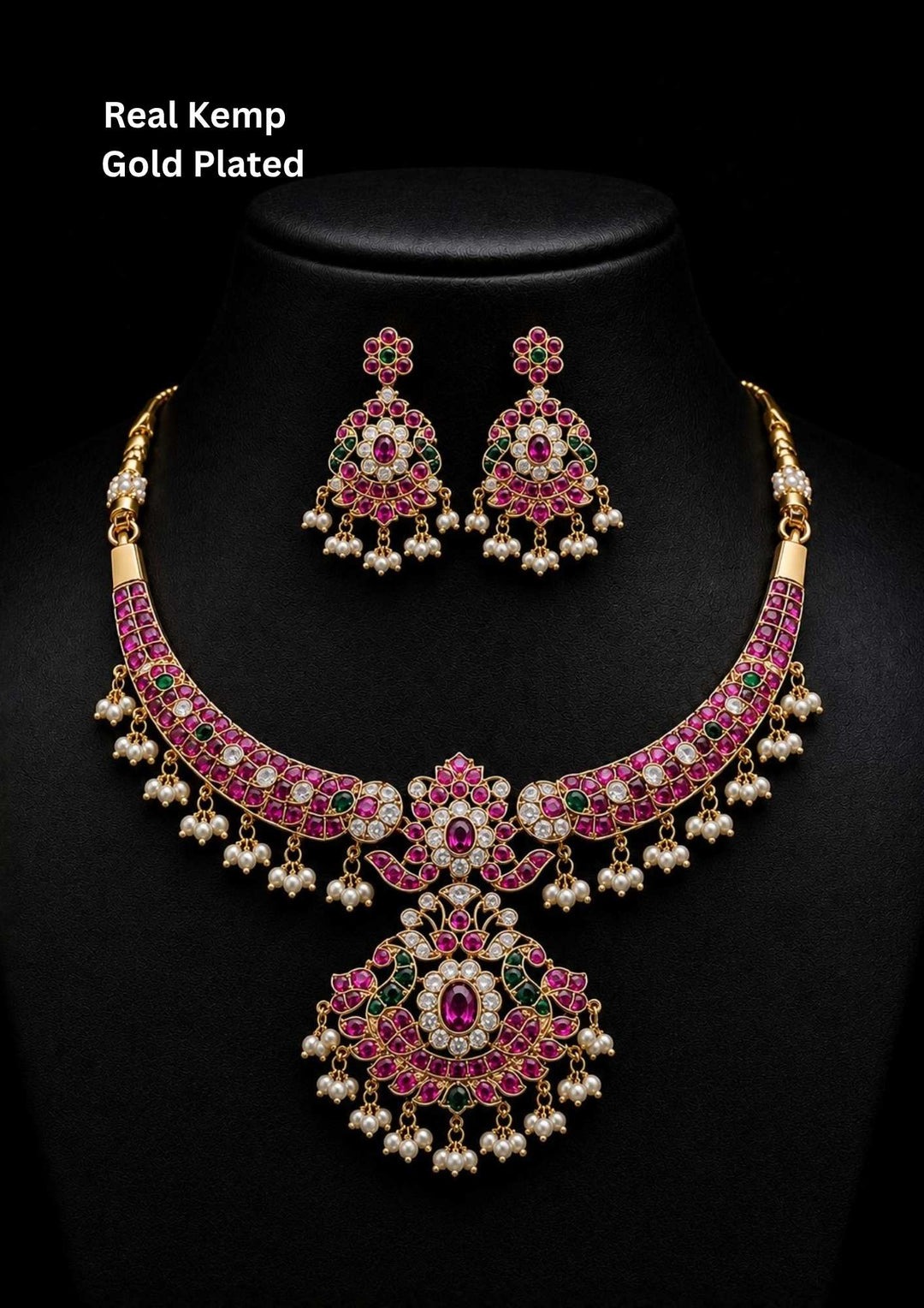 Jadau Kundan Gold Plated choker necklace and matching hanging earrings are designed with red ruby, emerald green, and white Kundan stones, finished with delicate white pearl guttapusallu upto the bottom borders. perfect for a rich, bridal-style look perfect for weddings, festivals, functions and grand look
