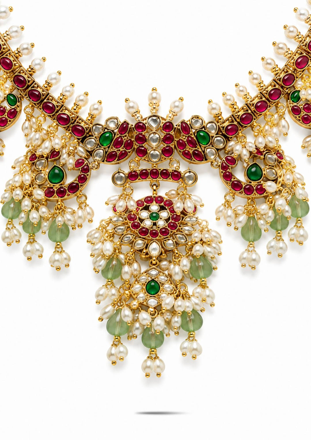 Gold necklace rice beads with red and green gemstones on a white background and pendent shown very clearly and in detailed way shown in picture it will sweat proof and water proof can used for festivals, bridals, and weeding's  