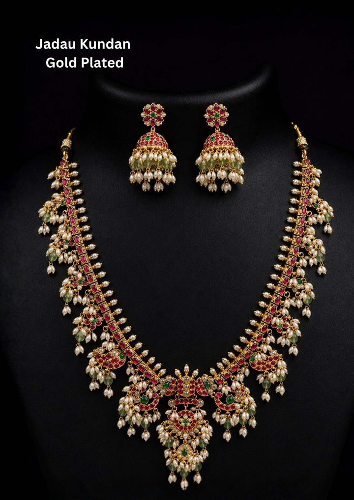 Gold-plated necklace set with intricate design long necklace Set and earrings  with rice beads green and red stones come with jadau kundan in necklace set  with beads and in pendent and earrings shows clear design and in detailed shown in picture it will not fade color and water proof can used for festivals, bridals, and weeding's  