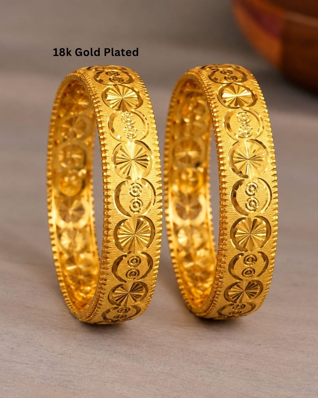 Traditional gold plated designer bangles featuring repeating floral and circular motifs with intricate textured borders, perfect for festive, wedding, and traditional occasions.