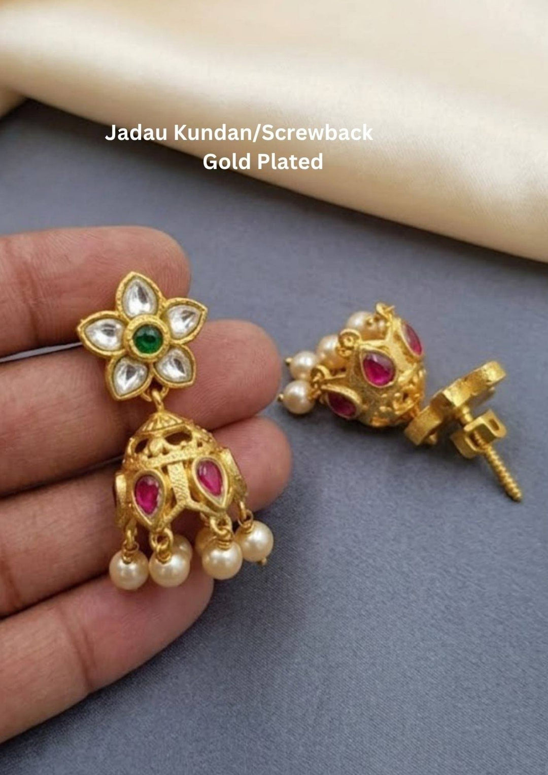 Gold plated earrings with gemstones and pearls jhumaks with waterproof, anti fade used for dailyware ,festivals weddings, and ideal for gifting.