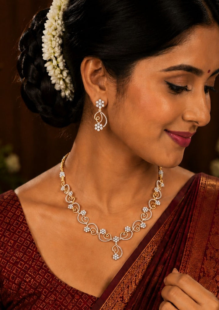 South indian women wearing a Zircon Diamond Gold Plated Swirl Design Necklace  featuring with love shape and flower shape and it has matching studs designed with zircon stones perfect for office wear, functions, paties, receptions and weddings . It is anti fade color