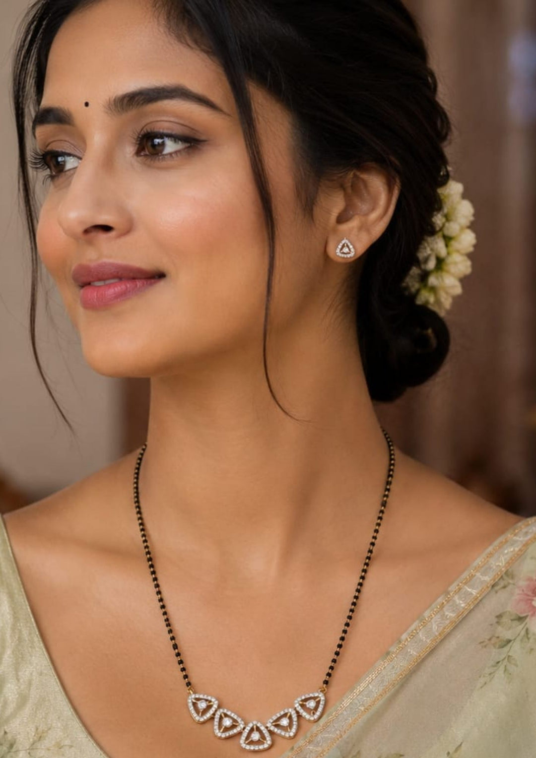 South Indian Woman wearing Gold plated black beads mangalsutra featuring an elegant -Triangular  inspired zircon centerpiece with delicate curved detailing. Lightweight and beautifully crafted for everyday elegance, festive occasions, and gifting.