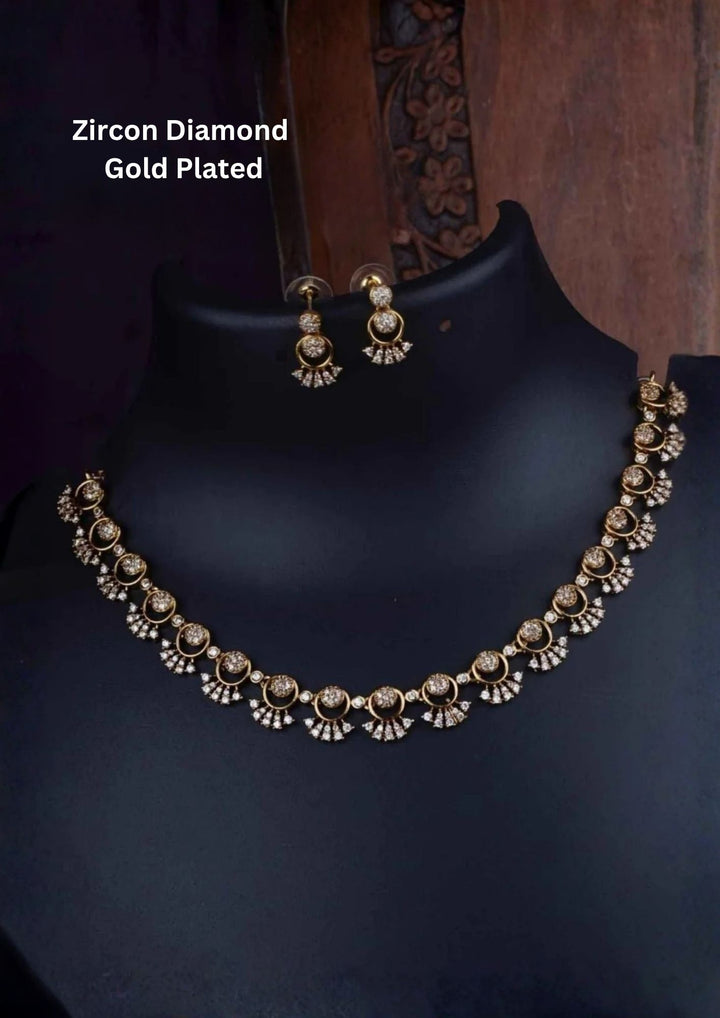 A delicate, lightweight 18k gold plated festive choker necklace featuring a continuous arrangement of open circular loop links. Each loop is accented with shimmering clear zircon diamonds that cascade down into tiny fan-shaped crescent drops, paired with matching dangling circular ear studs on a black presentation bust.