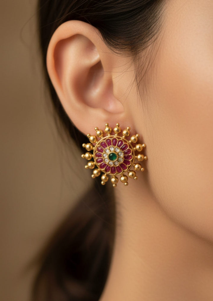Close-up of a gold earring with gemstones with  looks very traditional and elegant can use for dailyware , functional ware, festive ware and for gift 